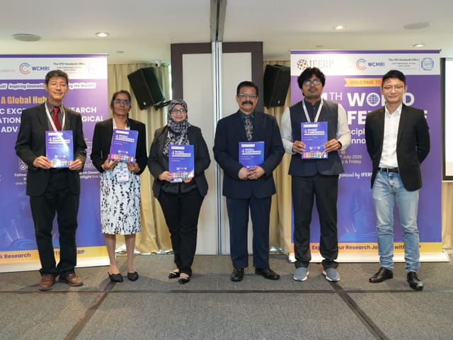 Delegates holding the printed proceedings at a previous WCMRI conference